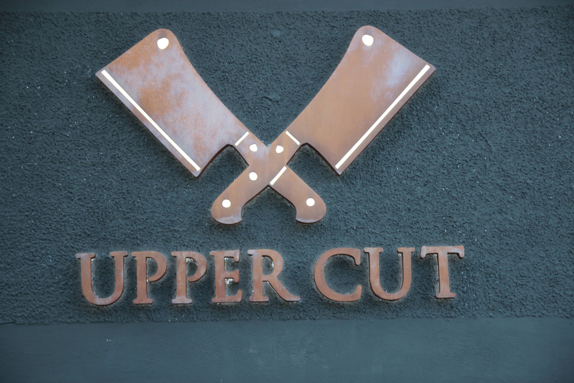 UpperCut crossed cleaver logo signage on restaurant facade — 410 Dewey Blvd Forest Hill San Francisco