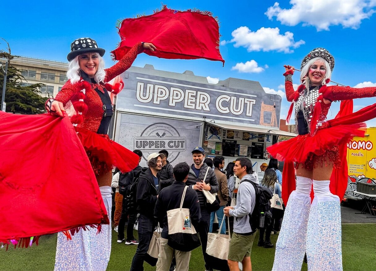 UpperCut food truck serving guests at Spark Social SF under a vivid sunset sky