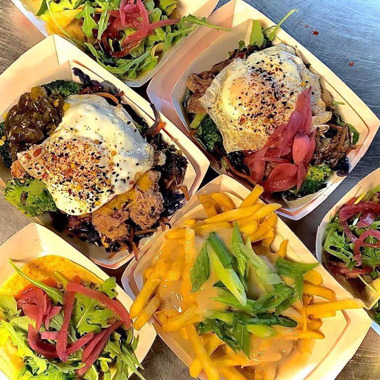 Happy guests enjoying UpperCut food truck bowls and sliders at Spark Social San Francisco